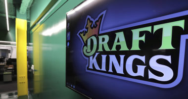 FILE - In this May 2, 2019, file photo, the DraftKings logo is displayed at the sports betting company headquarters in Boston. Sports gambling giant DraftKings won't give a former 